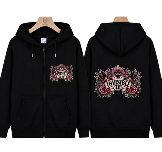 A black zip-up hoodie shown from both front and back on wooden hangers. The front has a small chest graphic reading 'The Invisible Club' with pink roses and a white eye motif.